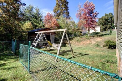 Large side and back yard safely fenced for family 