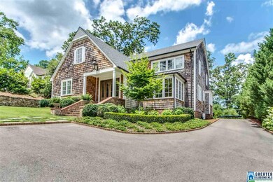 Brick lined driveway leads you up the path to the 