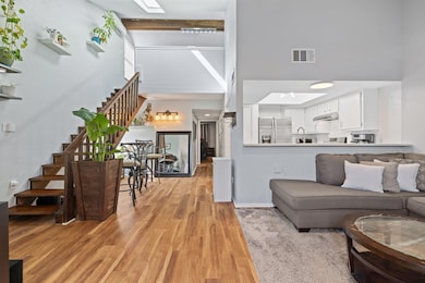 Living room featuring a high ceiling, light wood 