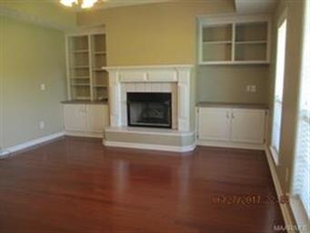 Family room features fireplace, built-in book case