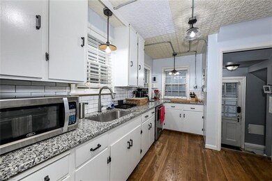 Kitchen with decorative light fixtures, backsplash
