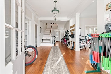 Foyer featuring crown molding, hardwood / wood-sty