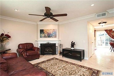 Spacious living room with cozy fireplace, crown mo