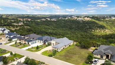 Aerial perspective of suburban area featuring a forest