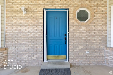 Property entrance featuring brick siding