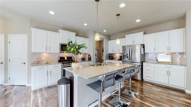 Pristine white kitchen with loads of granite and p