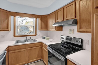 The kitchen features a generous amount of cabinets for storage.
