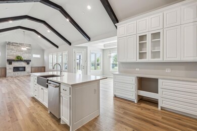 Kitchen with sink, white cabinetry, and an island 