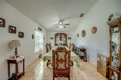 Dining room featuring light tile patterned floors and a ceiling fan