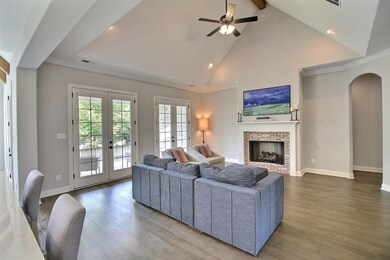 View of covered porch, back yard, and gorgeous tre