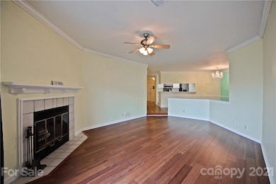 Great Room features bamboo flooring, wood burning fireplace, ceiling fan/light & patio access!
