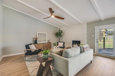 Living area with light wood-type flooring, a fire