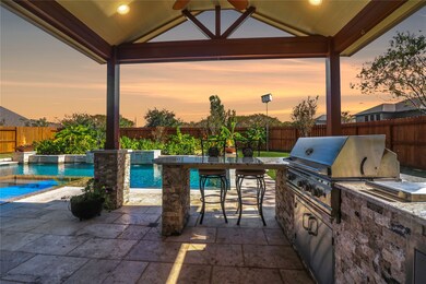Discover your private retreat with a luxurious outdoor kitchen, perfect for entertaining by the pool.