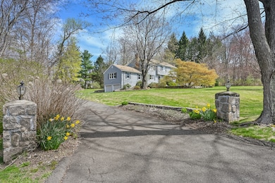 Paved driveway lined with flowering trees