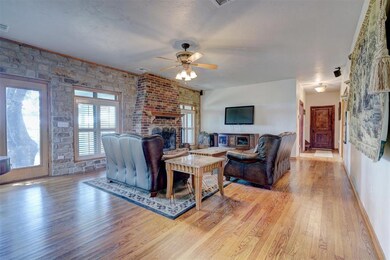 Living room with ceiling fan, light hardwood / woo