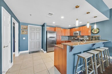Kitchen with tasteful backsplash, light stone coun