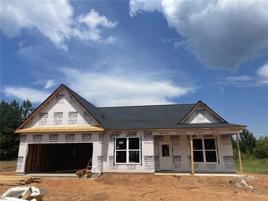 Property in mid-construction featuring a garage and a shingled roof
