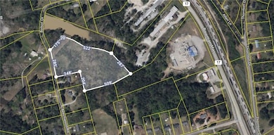 Aerial map of property and surrounding area featuring property parcel outlined