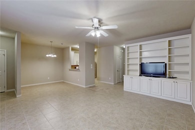 Unfurnished living room with ceiling fan with nota