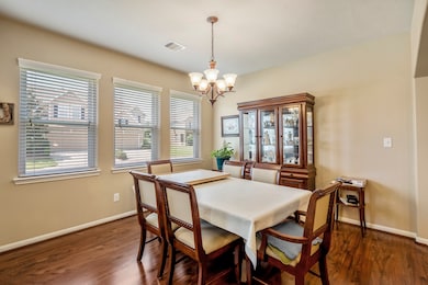 The dining area is surrounded by large windows tha