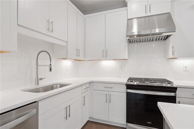 Kitchen featuring white cabinets, stainless steel 