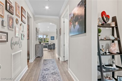 Hallway with light hardwood / wood-style floors an