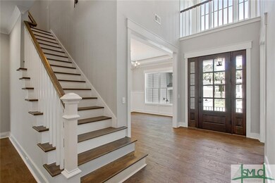 A stained white oak staircase greets you as you ma