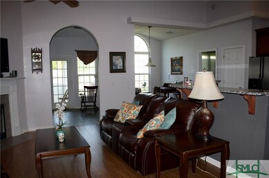 Open floor plan with island and breakfast bar.
