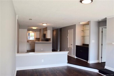 View from living room to dining, bar, and kitchen.