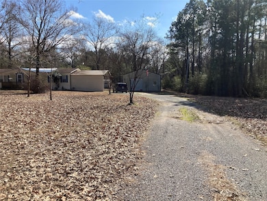 A long driveway leads from main road to home with plenty of extra parking and a covered attached carport.