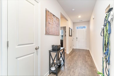 Entryway with baseboards and light wood-style floo