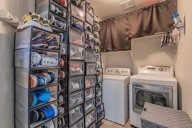 Laundry area with washing machine and clothes dryer and a textured ceiling