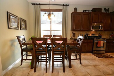 Breakfast room highlighted by tile floors, pantry and opens to the kitchen and dining room.