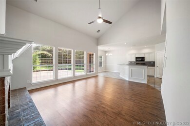 Wall of windows overlooks backyard & deck.