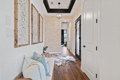 Hallway at the entry thoughtfully separates the main living space from the secondary bedroom and second living space.