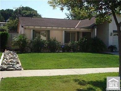 Custom riverrock landscape leading up to side yard