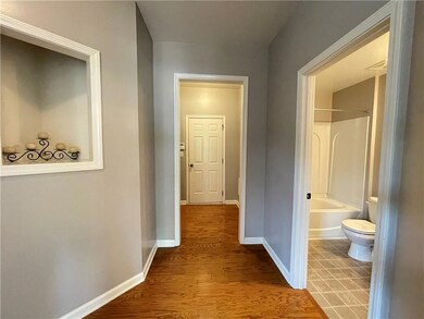 Corridor with wood finished floors and baseboards