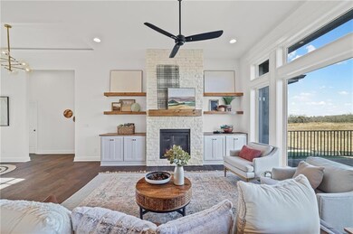 Living room featuring a fireplace, dark wood finished floors, recessed lighting, and ceiling fan