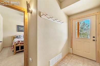Entryway with light tile patterned flooring, visib