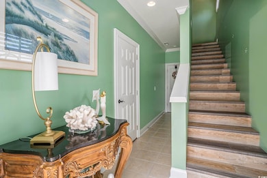 Stairs featuring tile patterned floors, recessed lighting, and crown molding