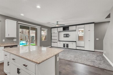 Kitchen with light stone countertops, baseboards,