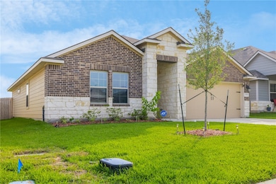 View of front of house featuring brick siding, a f