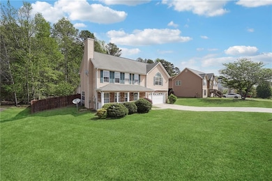 View of front of house with driveway, a front yard