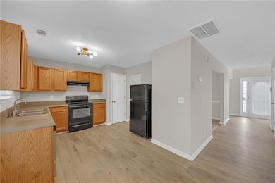 Kitchen with under cabinet range hood, visible ven