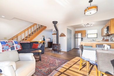 Living room featuring wood finished floors, basebo