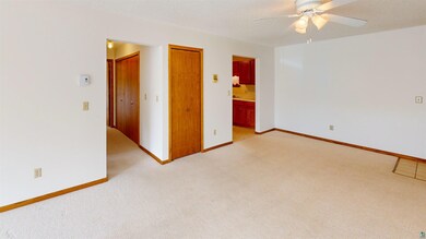 Unfurnished room featuring light carpet and ceiling fan
