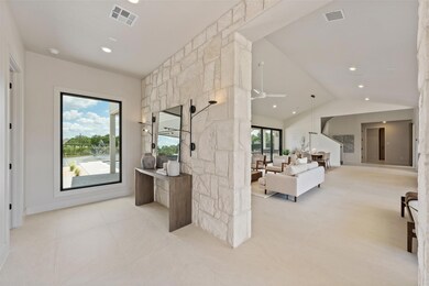 Living room featuring a ceiling fan, light tile p