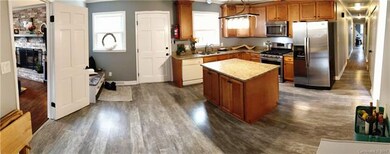 Living room leads to the large kitchen with lots of cabinets and counter space. There is a Lazy Susan cabinet in lower corner and most of the lower cabinets have chrome pull-out drawers. All appliances pictured convey. The Kitchen leads to long hallw