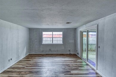 Unfurnished room featuring wood finished floors and a textured ceiling
