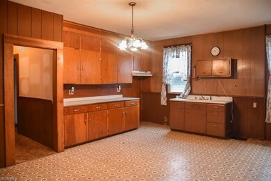 The kitchen has a farmhouse sink with a drain boar